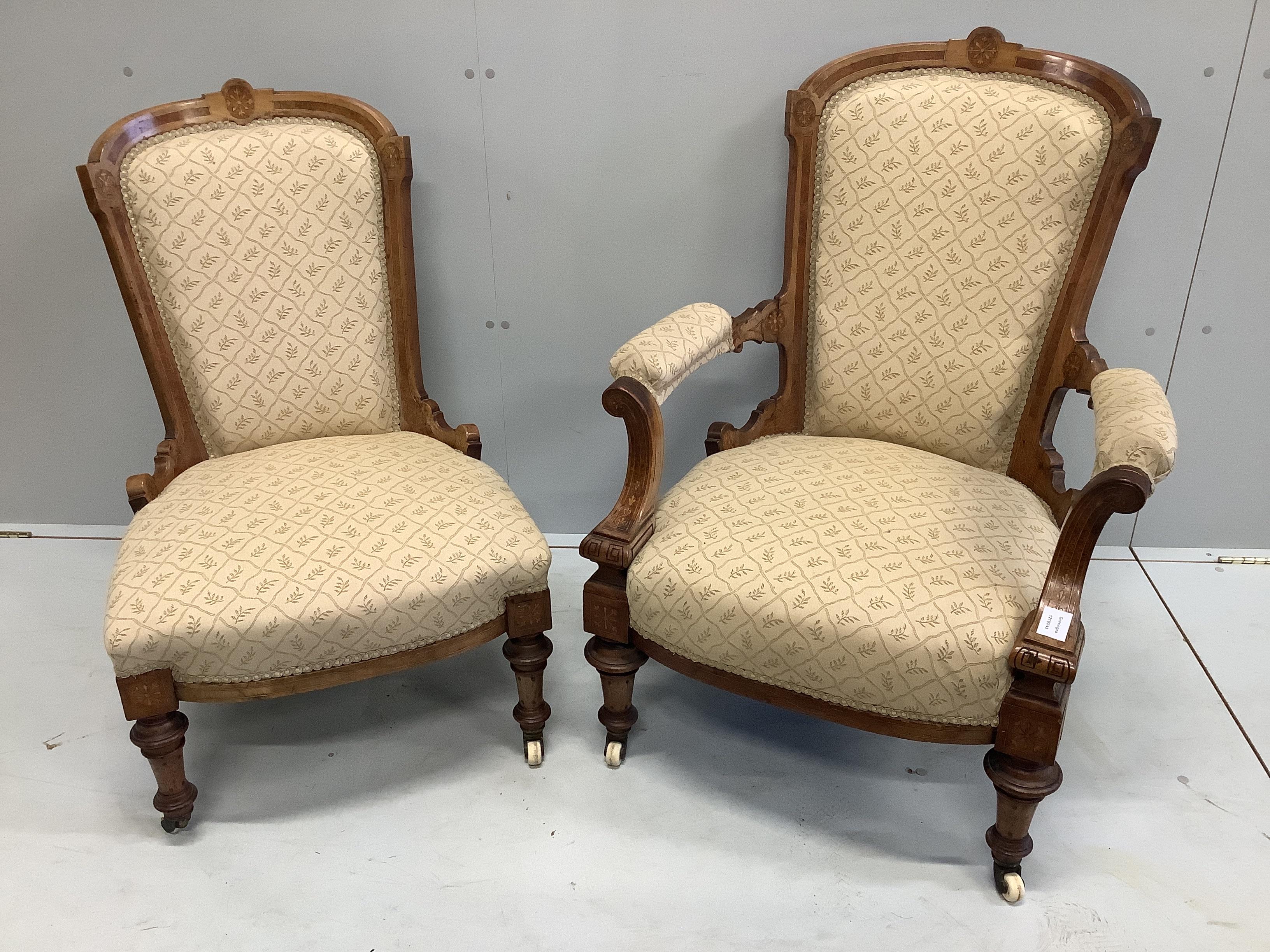 A pair of Victorian amboyna banded walnut salon chairs, one with arms, larger width 72cm, depth 74cm, height 94cm